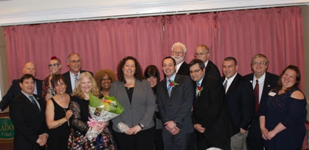 Dr. Velazquez (holding a flower bouquet) is pictured with other board members of the Brookhaven Coalition Chambers of Commerce and other honorees at the ceremony.